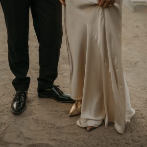 Wedding Photographer Spain Italy Greece France Germany-2 Bride and groom's feet in the sand with fancy shoes