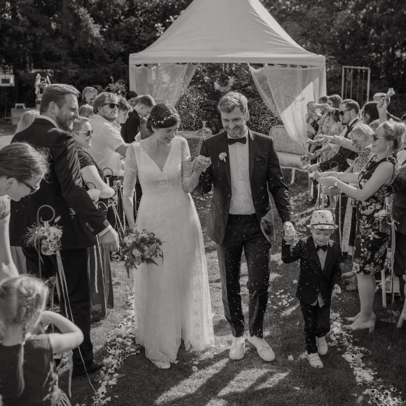 wedding photograph thuringia saxony saxony anhalt Wedding couple leaving after the ceremony surrounded by their guests with soap bubbles